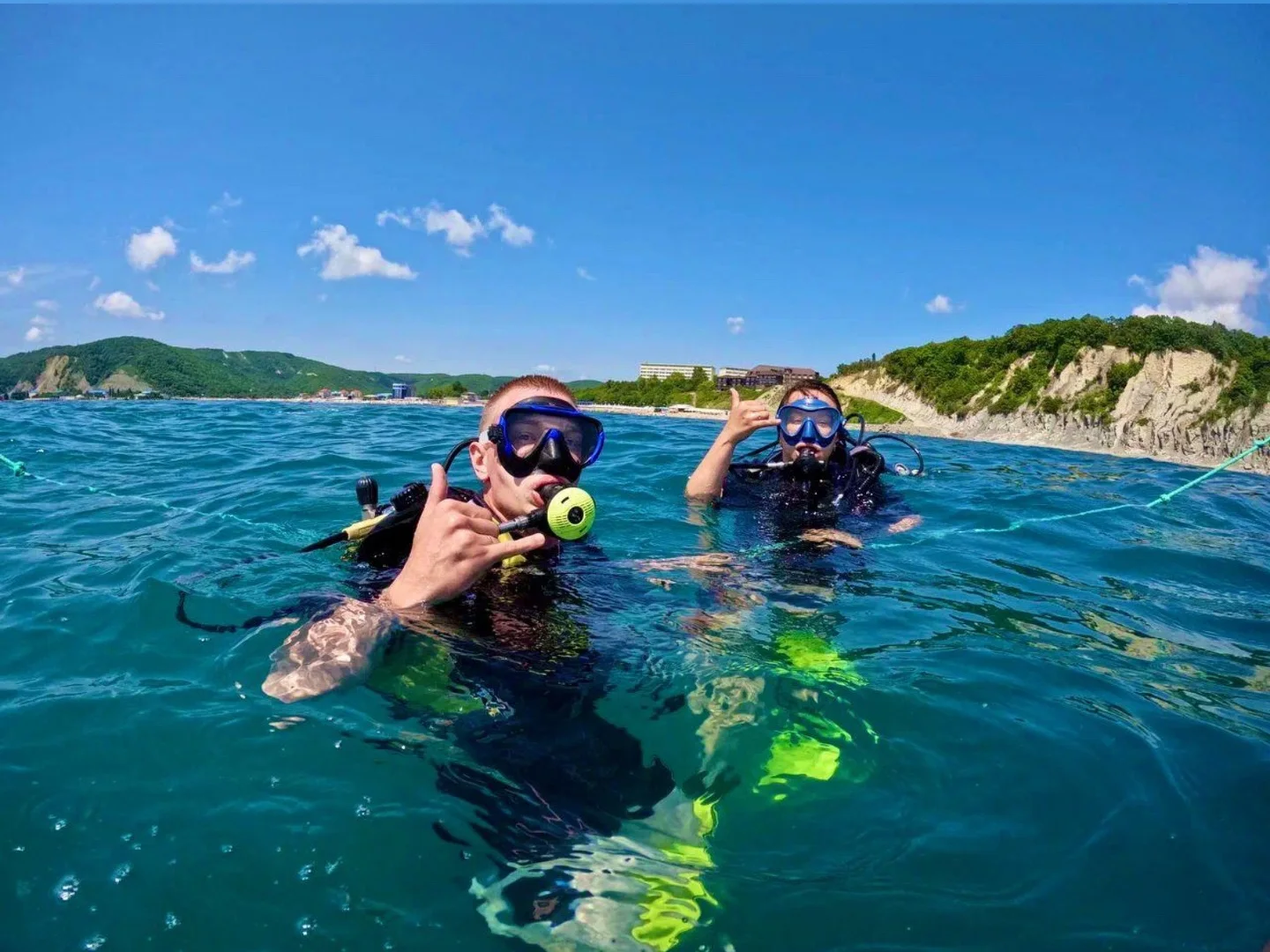 Два дайвера на поверхности моря у берега